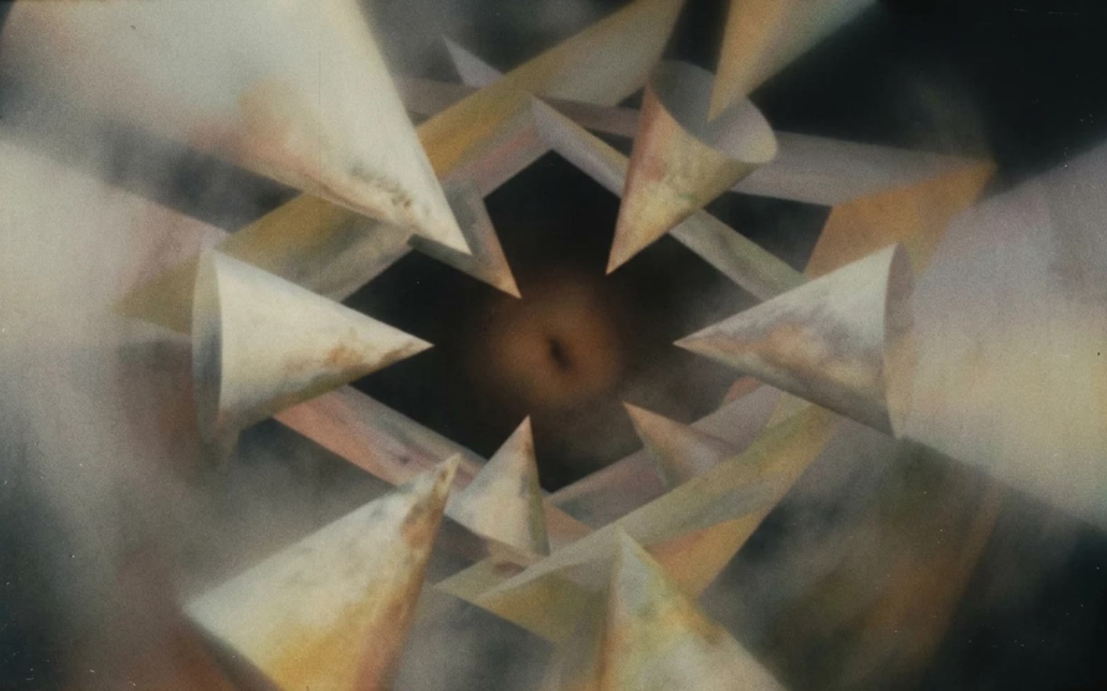 A still from The Dream Atlas: pale paper cones circling a dark centre